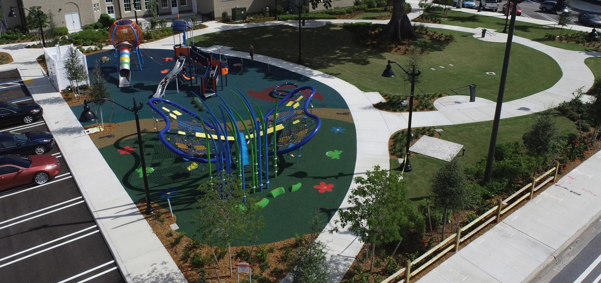 Playground equipment with sidewalk and kapok tree