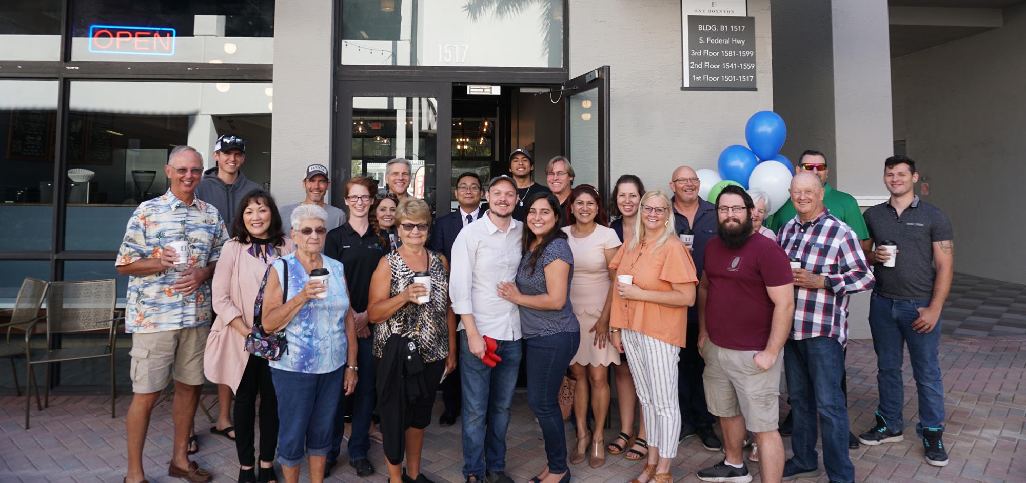 Group photo at riboon cutting for Common Grounds Brew & Roastery