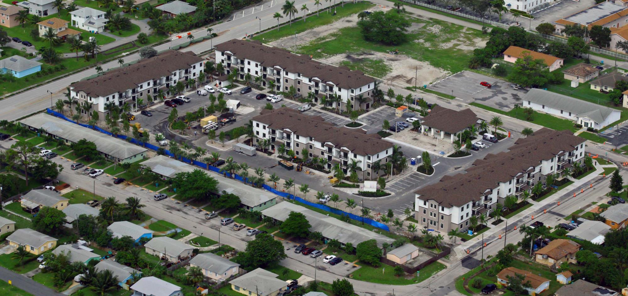 Aerial View of Ocean Breeze East Apartments which includes 5 buildings and parking lot areas